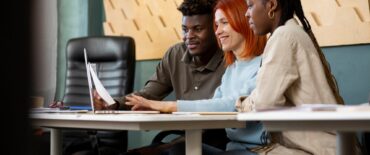 medium-shot-people-working-office-together_23-2149337277