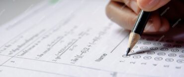 students-hand-holding-pencil-writing-selected-choice-answer-sheets-mathematics-question-sheets_9635-2894